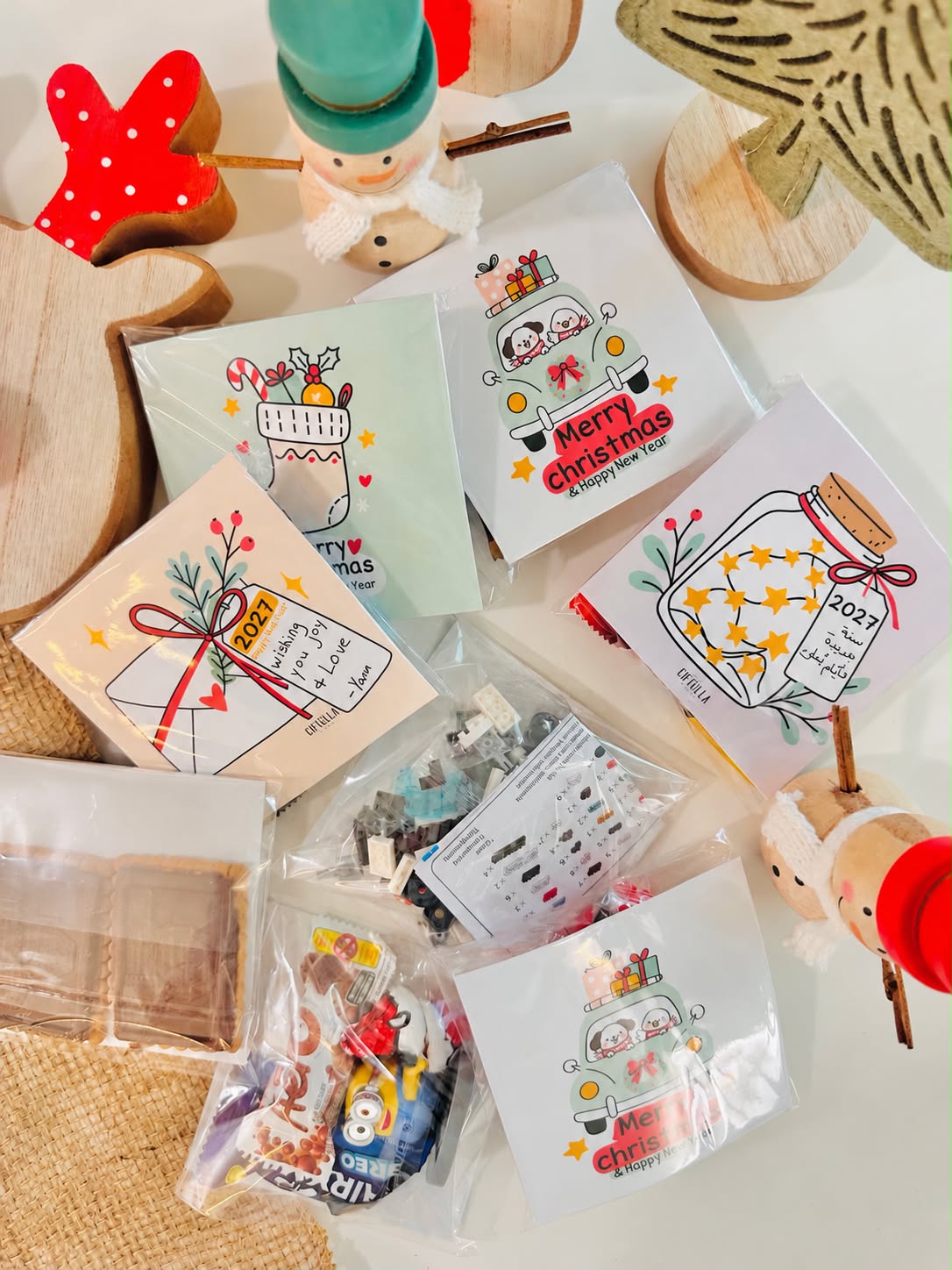 Christmas cards in clear bags with biscuits, chocolates and toys, with a handwritten message on the 2027 tag