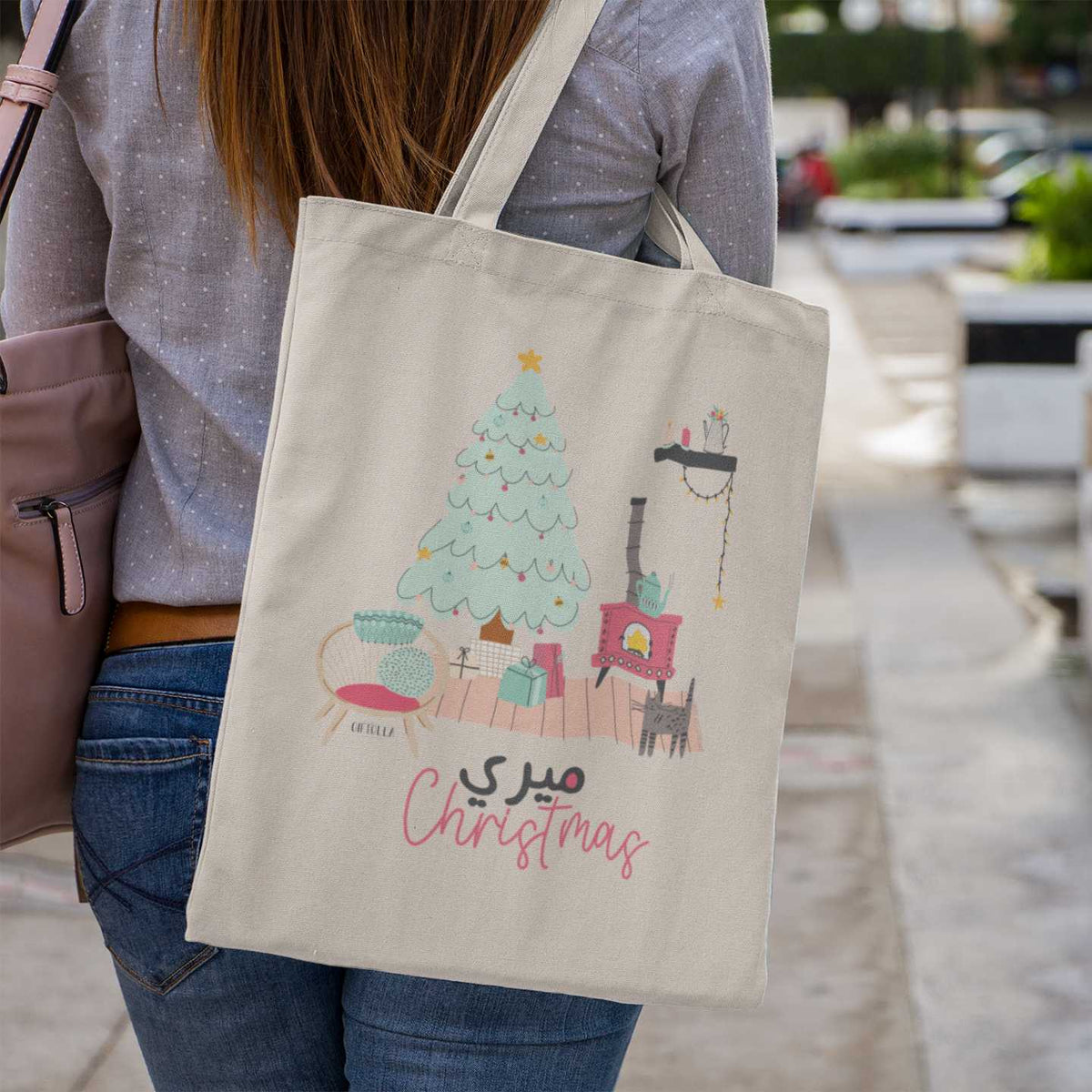 Merry Christmas tote bag by Giftolla carried over a woman's shoulder